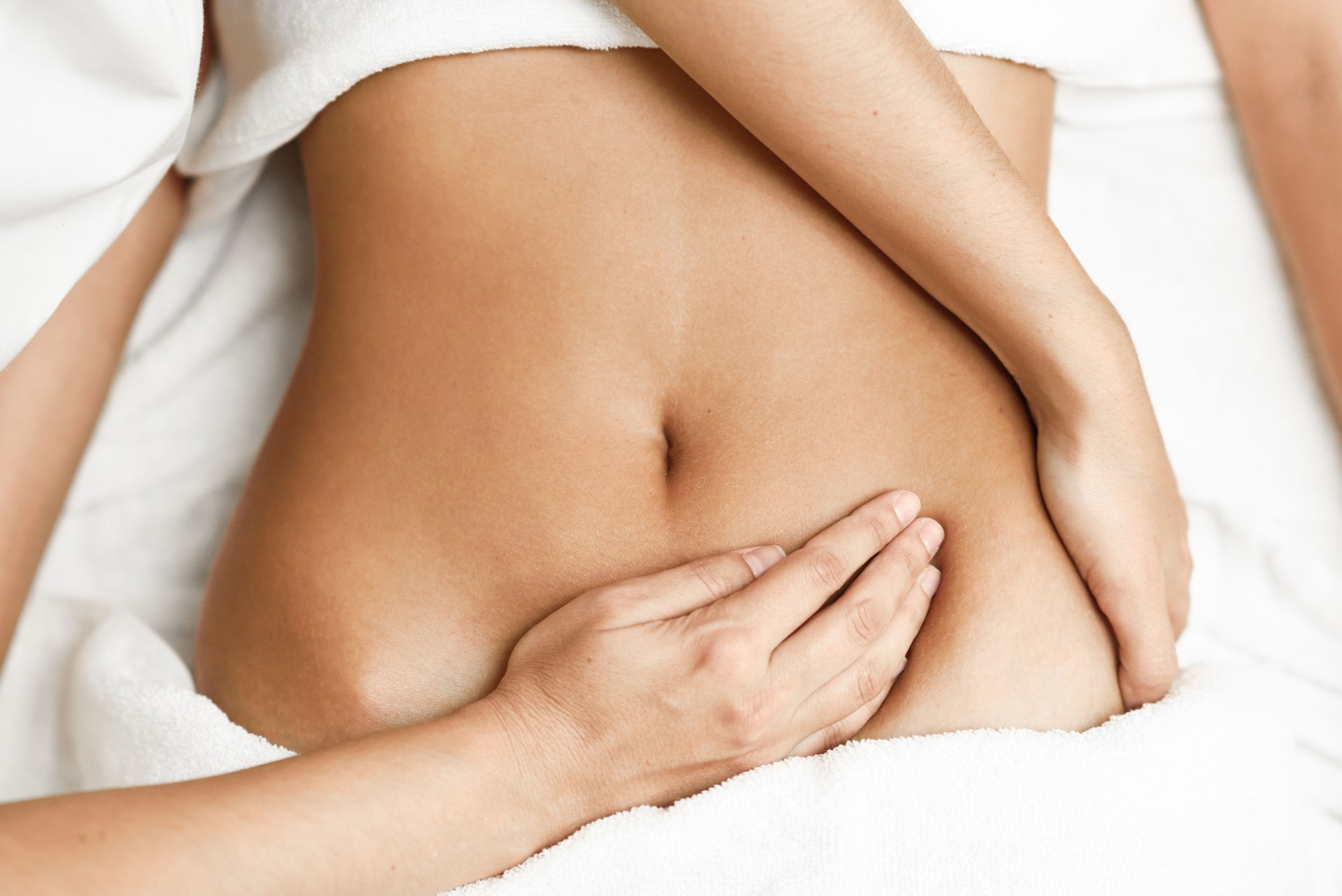 Midsection Of Massager Massaging Woman