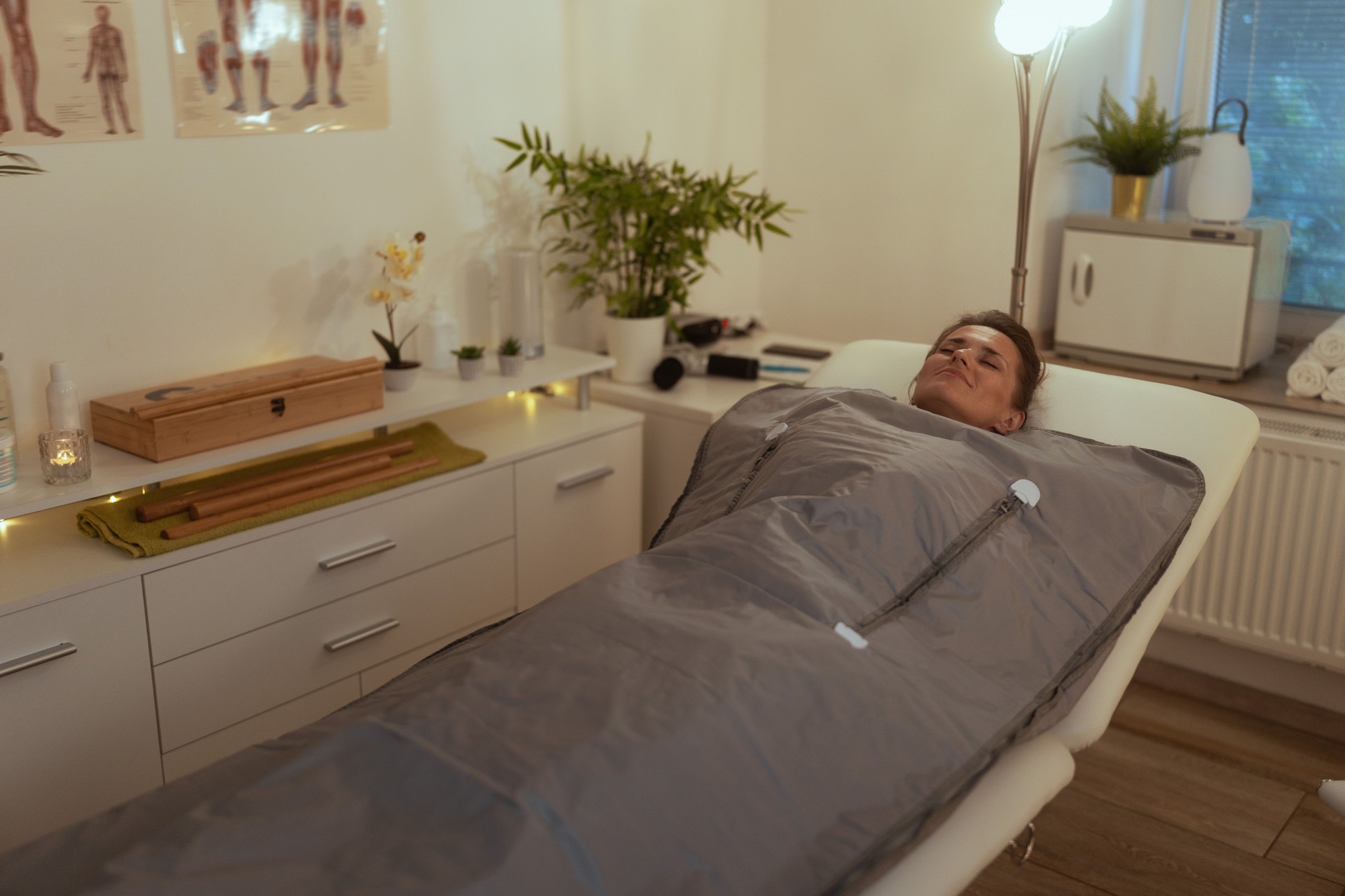 woman doing whiskey swaddling procedure in thermal blanket